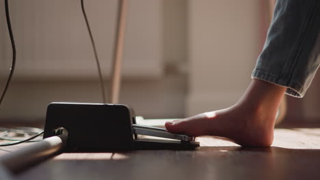 child pianist changes sound pressing pedal with bare foot