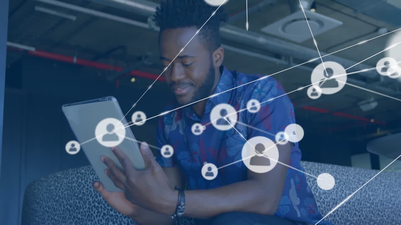 Using tablet, man interacting with animation of social network connections in school