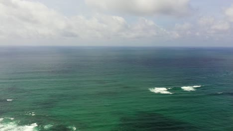 blue ocean with waves and blue skies with clouds.