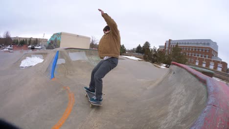 skateboarder does a 360 heelflip at the skatepark