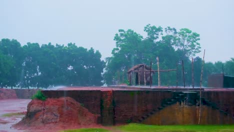 rain-soaked ancient ruins with huts in bangladesh - historical place