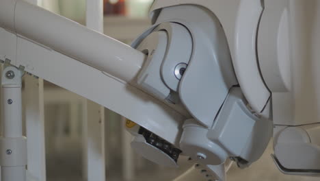 Closeup-of-stair-lift-moving-on-rail-with-childs-feet-dangling-above-seat