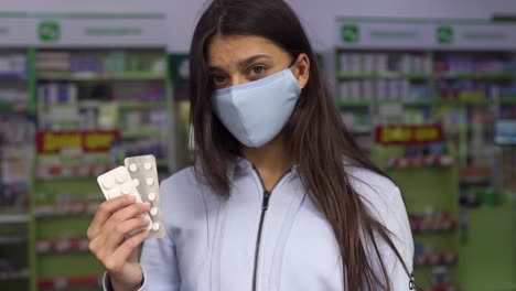 woman in pharmacy looking at medication