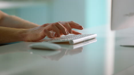 Closeup-hands-typing-keyboard-at-modern-office.-Manager-using-wireless-device.