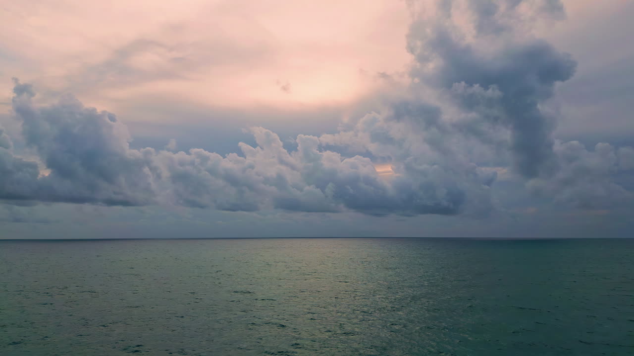 Calm sea under cloudy sky