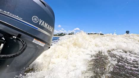 speedboat creating waves on a sunny day