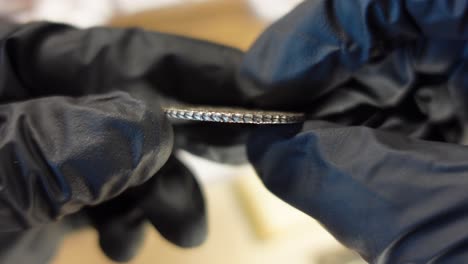 collector examining portuguese silver coin from the modern age