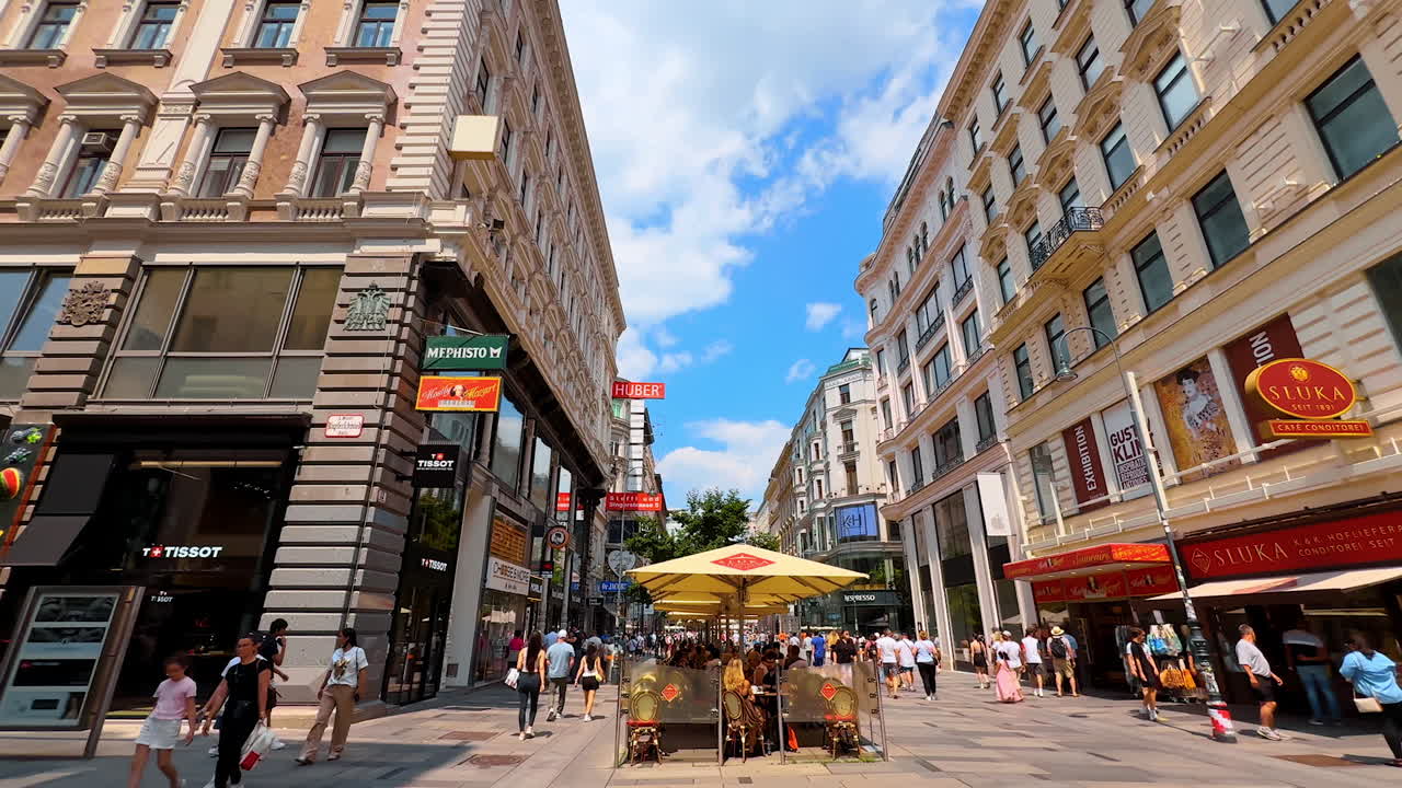 Vienna, Austria - June 9, 2025: Enjoying a lively afternoon in Vienna. Tourists explore the vibrant streets of Vienna, surrounded by stunning architecture and lively cafes on a sunny day