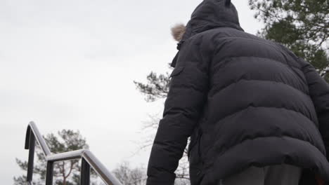 hooded anonymous male gangster, walking in the hood in jacket, slow motion