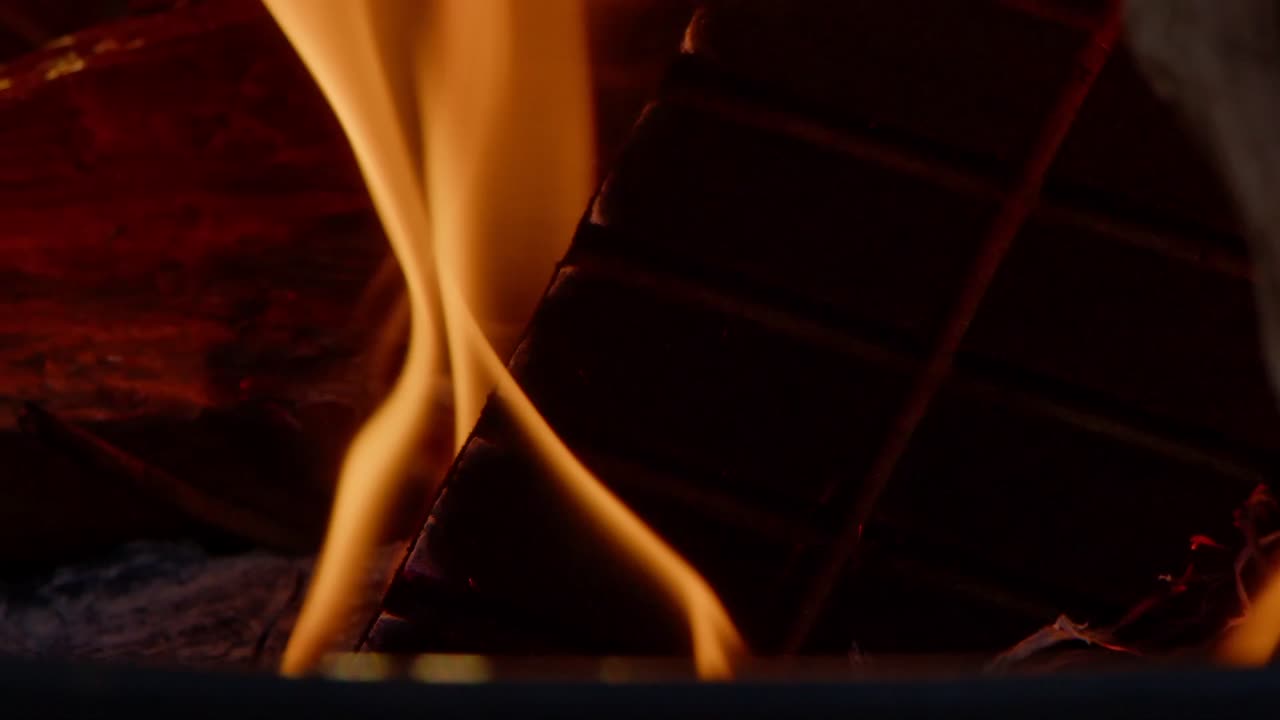 Close up, flames of a wood-fire burning against black background