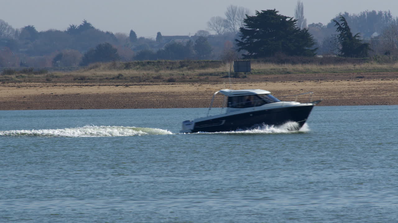 Speed boat entering and exiting frame on the sea at Brightlingsea
