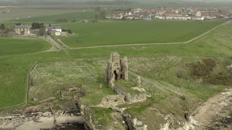 An-aerial-view-of-Newark-Castle-on-the-Fife-coastal-path,-Scotland