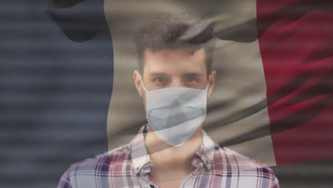 Animation-of-flag-of-france-waving-over-latin-man-wearing-face-mask-in-city-street