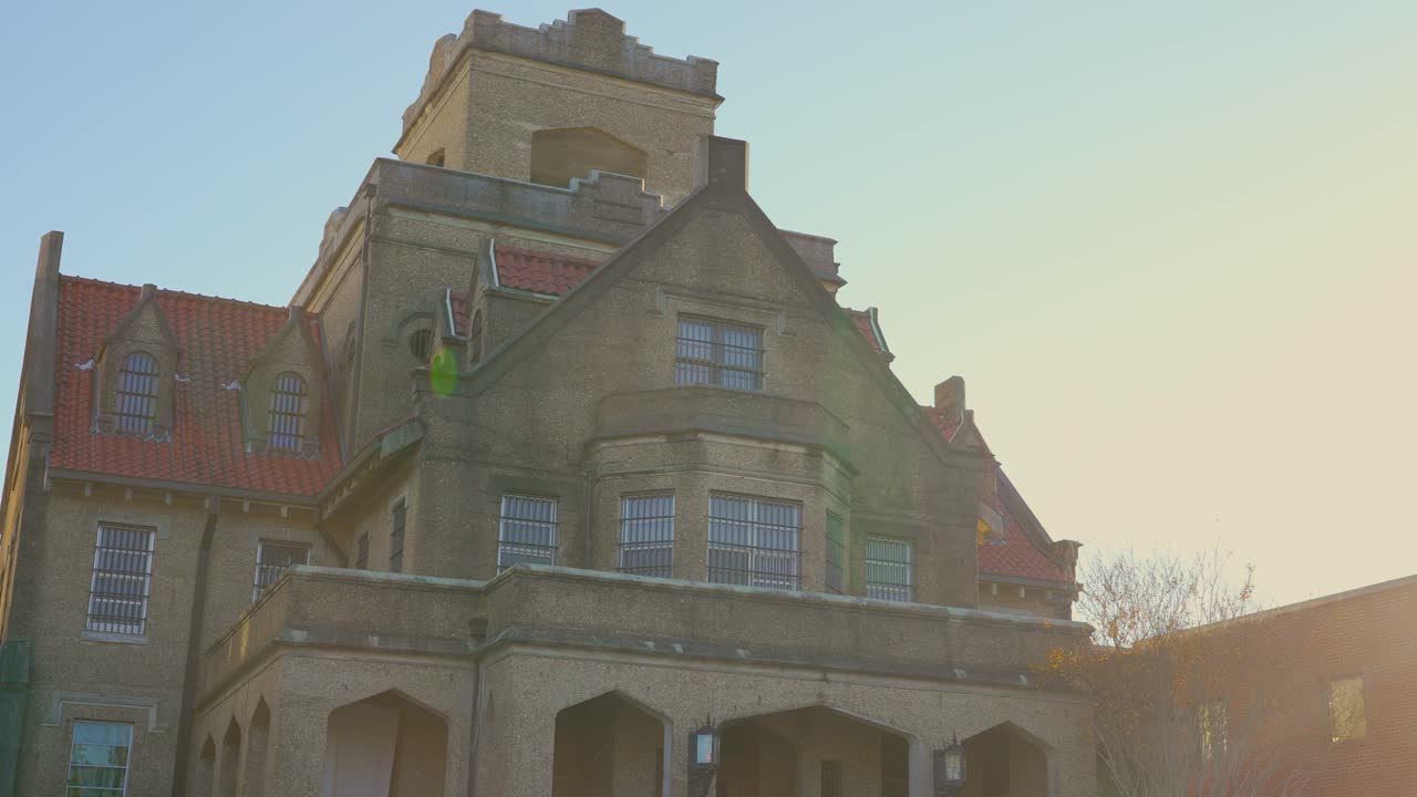 A panning shot with lens flares of the historic Old Hanging Jail in DeRidder, Louisiana. It is a historic site rumored to be haunted