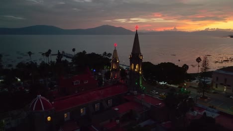 aerial view of a church at night in a lakeside town in mexico