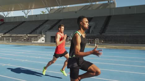 two athletes running in stadium