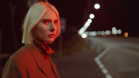 young woman standing on road in night