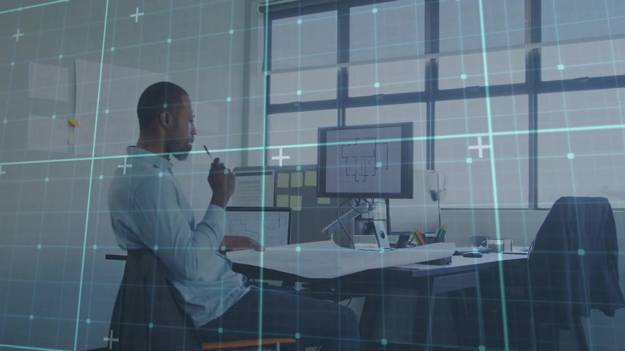 Architect adjusting plans, reaching monitor, pointing and reviewing drawings under thin blue grid