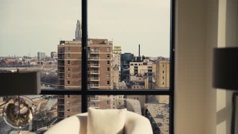 revealing-shot-of-the-iconic-Gold-Medal-Flour-sign-in-downtown-Minneapolis-through-the-windows-of-a-high-rise-condominium