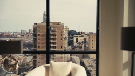 revealing shot of the iconic Gold Medal Flour sign in downtown Minneapolis through the windows of a high rise condominium