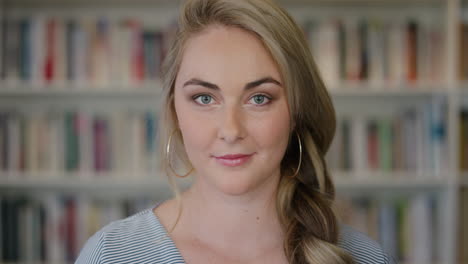 close up portrait beautiful young blonde woman student smiling confident independent in library background