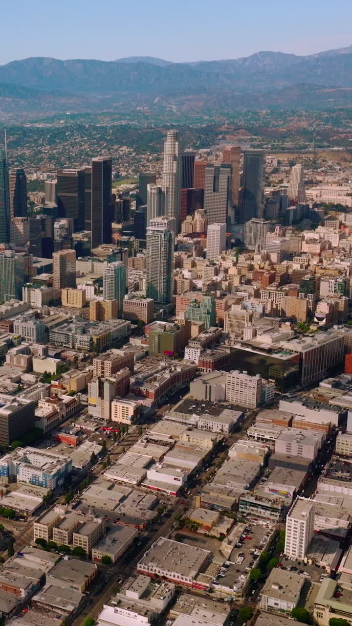 Los Angeles financial centre with beautiful skyscrapers. Scenic view of great city in California at the backdrop of hills. Vertical video