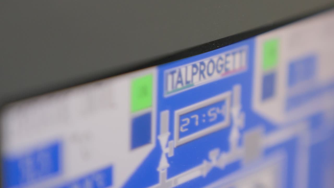 Close Up Shot Of An Automated CNC Machine's Computer Monitor Displaying Program Parameters.