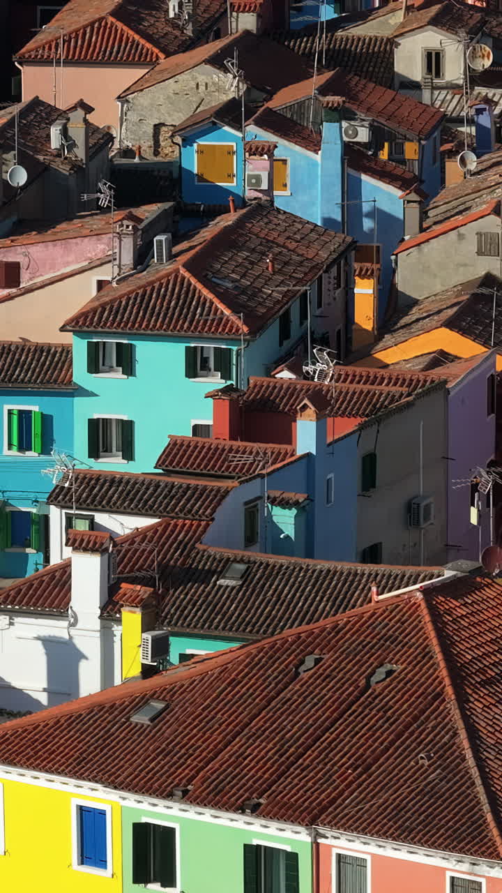 Aerial drone view of the colourful houses of Burano Island, Italy. Vertical
