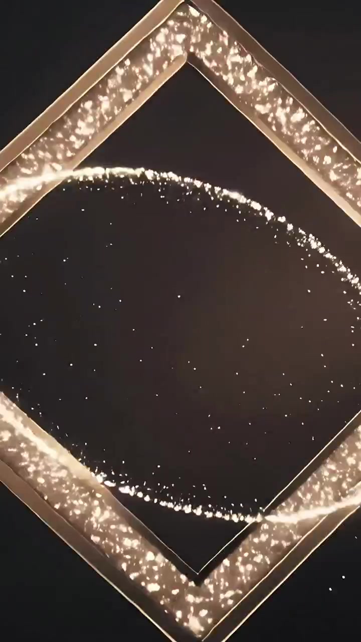 Video verticale: Striscia d'oro che si evolve ed esplode in una nuvola, con nuclei che tracciano cornici dorate su un vuoto nero.
