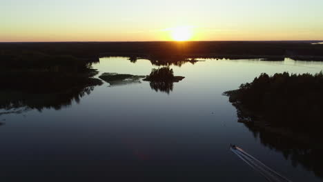 drone footage of boat driving in beautiful sunset