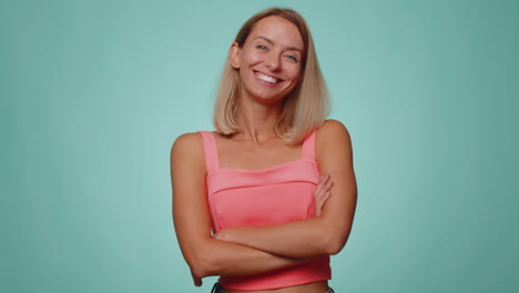 cheerful lovely blonde young woman fashion model in crop top smiling and looking at camera alone