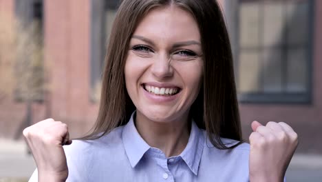 winning woman celebrating success, outdoor