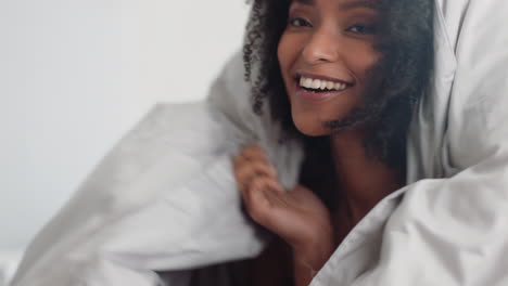 beautiful-woman-playing-in-bed-hiding-under-blanket-having-fun-enjoying-playful-morning-at-home