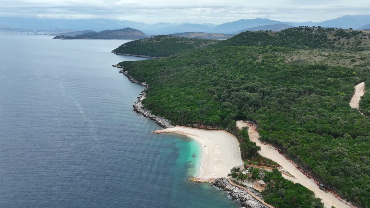 Remote beach with turquoise water and green hills, aerial view in Albania