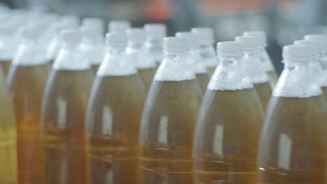 conveyor belt with bottles for juice or water at a modern beverage plant. modern production of sweet soda water