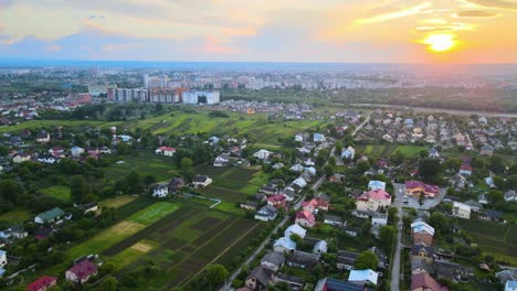 aerial view of residential houses in suburban rural area at sunset