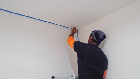 man painting white wall using paintbrush - close up