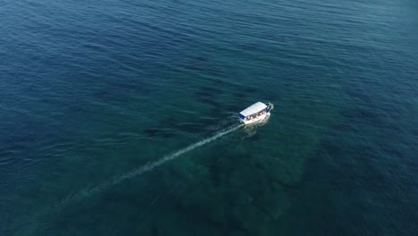 tourist boat sails over blue sea