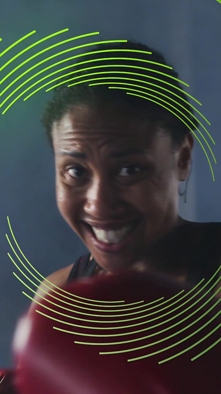 Vertical video: Boxer bringing red gloves, jabbing while green ring tracking punches for fitness