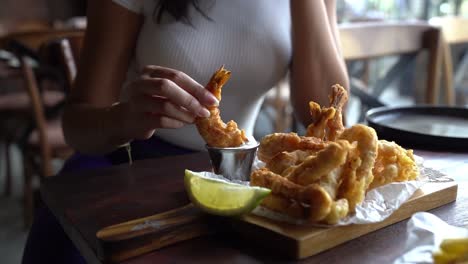 a woman eating her delicious lunch in fancy restaurant, close up shot,insert shot