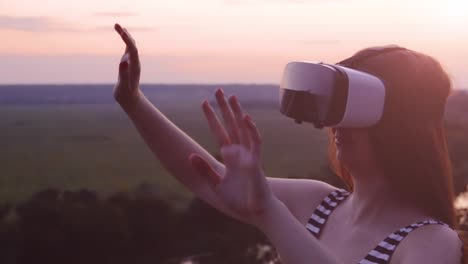 woman experiencing virtual reality at sunset