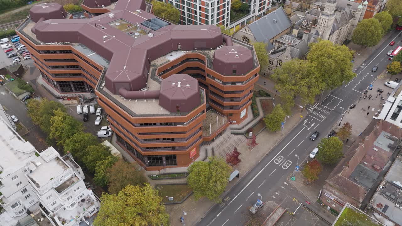 Rising aerial view of Ealing Council headquarters in London, showing surrounding roads and greenery, Ealing, London, UK, October 2024