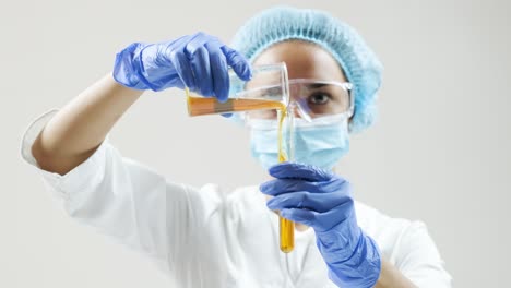 scientist pouring liquid into a test tube