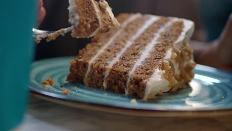 close up of a delicious slice of carrot cake with a fork