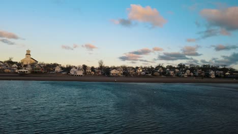 Slow-aerial-dolly-shot-of-seafront-apartments-looking-over-the-ocean-in-Provincetown