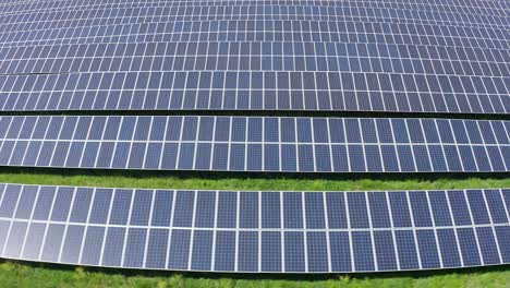 Aerial-fast-dolly-shot-across-an-endless-solar-farm-in-rural-Minnesota