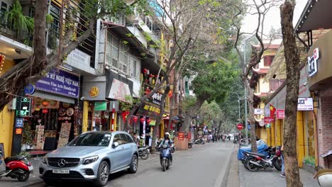 motorbikes and cars on a bustling street