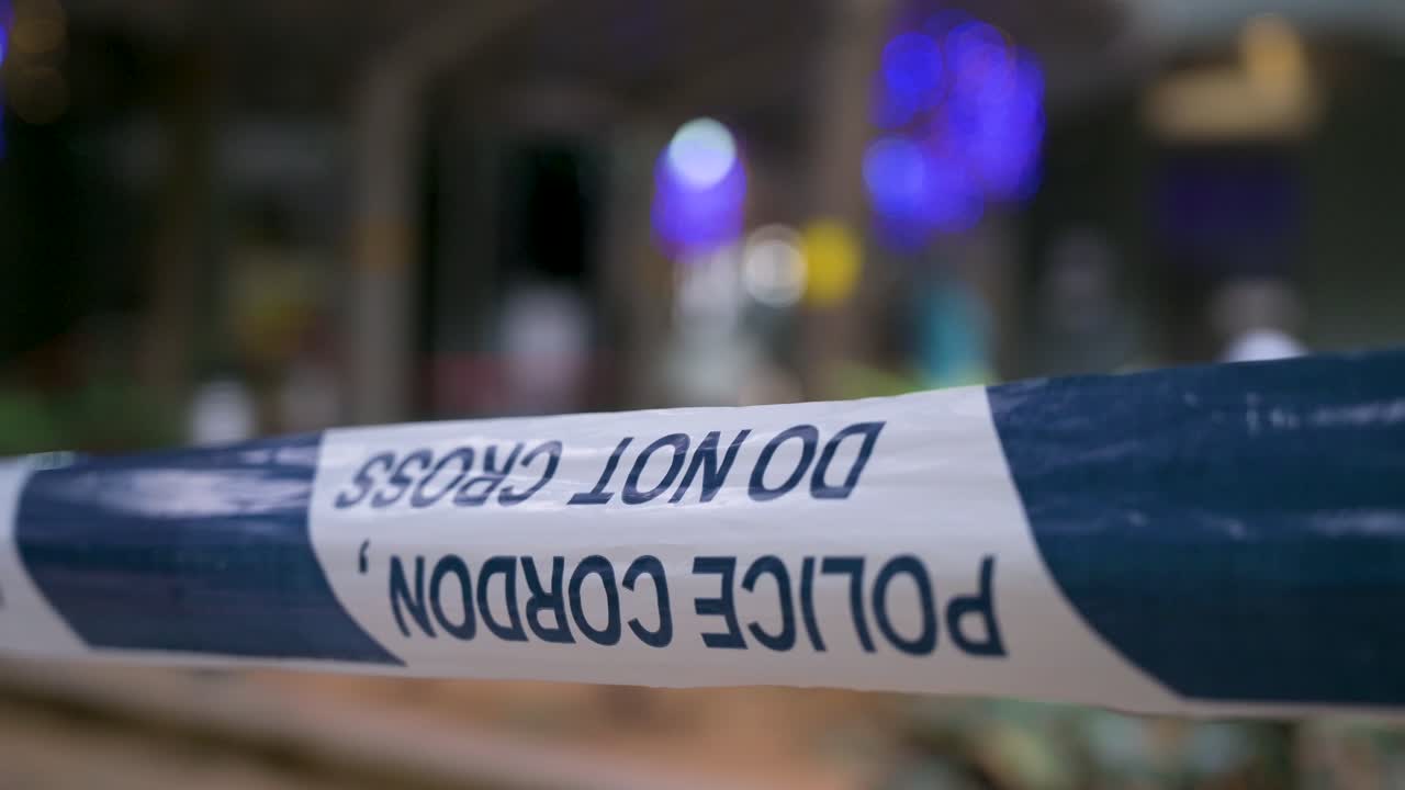 Police cordon tape is seen in the foreground as a neighborhood area is under lockdown to contain the spread of the Coronavirus variant outbreak in Hong Kong
