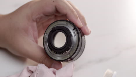 Cleaning-the-rim-of-a-camera-lens-using-an-old-toothbrush-and-a-soft-microfiber-cloth