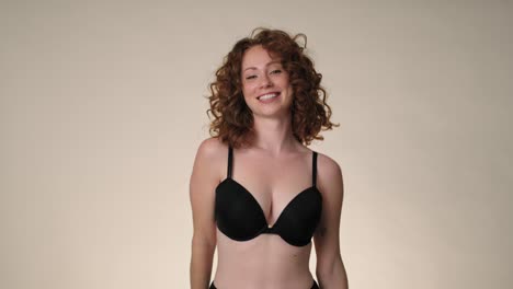 Cheerful-caucasian-red-head-woman-in-underwear-in-the-studio.